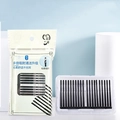 Disposable black adhesive ear swabs in sealed bags with portable white storage holder - White Packaging (C1FK7) / Black