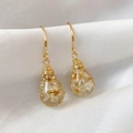 Detail view of handmade teardrop resin earrings featuring real white dried flowers. - Style 1 (HE31316) / White