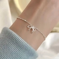 Elegant aurora silver bracelet with a bow pendant on a wrist for women's accessory - Silver Fine Chain Bow Pendant (MY36161)