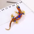 Vintage lizard brooch featuring orange enamel and blue sparkling rhinestone accents - Orange Enamel Lizard