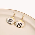 Macro shot of cute cartoon cat paw and moon dangle earrings on a ceramic dish - Heart Cat Claw Moon