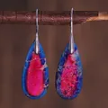 Detailed view of teardrop stone earrings hanging on a natural wooden branch - Royal Blue and Magenta Stone Style (ER1025-16)