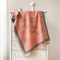 Detail of coral cashmere scarf featuring traditional Chinese floral patterns and soft tassels - 190x65cm / Pink