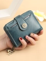 Short turquoise tassel wallet for women with daisy button and floral charm detail - Blue