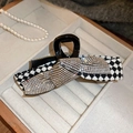 Macro detail of checkered hair claw clip with rhinestones and elegant bow design - Black And White Checkerboard Bow Clip