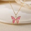 Elegant gold necklace with pink marble enamel butterfly pendant on white ceramic plate - Pink Textured Butterfly