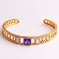 Close-up of gold chain-style open bangle featuring a large purple square zircon stone - Purple Zirconia