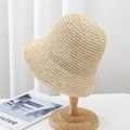 Beige woven straw sun hat with breathable hollow knit pattern on a wooden stand - 6cm Brim / Beige