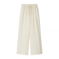 Close-up of cream wide-leg trousers featuring elastic waistband and vertical texture - Pale Yellow Pants