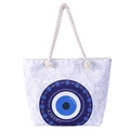 Detail of canvas beach tote with blue evil eye motif and white woven rope handles - Greek Style