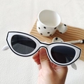White cat-eye Y2K sunglasses with black line details and dark lenses held by hand - White Frame Black Lines