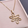 Macro view of golden stainless steel flower pendant with refined hammered texture details - Pendant Necklace / Gold