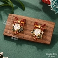 Detailed view of Christmas bow earrings with pearls and crystals on a festive background - Christmas Red Bow Clover Studs / Wine Red/Gold