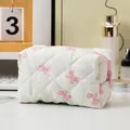Quilted floral makeup bag with pink bow pattern and functional zipper closure - White Base Pink Bow