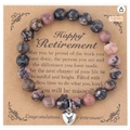 Pink and black stone bead retirement bracelet with a silver heart charm on card - Rhodonite + Retirement Card