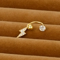 Macro detail of a gold lightning bolt belly ring with inlaid zircons on brown velvet - Lightning Design Style (Y20370-11)