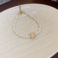 Elegant pearl bracelet featuring a gold square pendant with a pink stone and shell tray - Artificial Pearl Bracelet Style 84