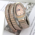 Close-up of snake-shaped wrap watch with crystal-set bezel and two-tone metal band - Rose Gold Gradient Rose Gold Dial
