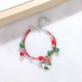 Detail of Christmas beaded bracelet featuring bells, wreath charm and woven rope - Style K Xmas Wreath
