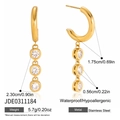 Macro view of C-shaped stainless steel earrings with sparkling white zircon drops - Gold Triple Zirconia Pendant Style (JDE0311184)