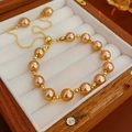 Detail of champagne pearl bracelet with adjustable gold chain in a wooden jewelry box - Champagne Style