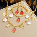 Gold insect and pearl jewelry set featuring ladybug and dragonfly pendants on a beige mat - 3-Piece Set (N3556 E6251 B1738)
