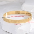 6mm gold-plated stainless steel oval bangle featuring embossed Roman numerals on a white stone - 6mm Wide / Gold