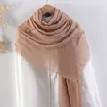 Light brown cotton linen scarf with frayed edges and natural crinkled texture on shirt - Tan