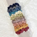 Metallic satin scrunchies set in various colors displayed on a cylindrical stand - Shimmer Glossy Multicolor