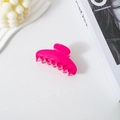 Detailed view of a high-gloss magenta acetate shark clip with minimalist elegant curves. - Rose Red