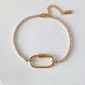 Bracelet tennis en acier plaqué or 14K avec breloque ovale polie et détails de coquillage - Style Chaîne Tennis Or 14K (XBL0060-2)