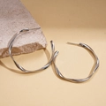 Minimalist silver geometric twisted hoop earrings displayed on a natural stone background - Twisted Round (6cm) / 6CM Diameter / Silver