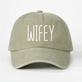 Close-up detail of white WIFEY embroidery on washed khaki olive baseball cap soft crown - Light Khaki