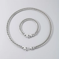Polished silver stainless steel Cuban chain necklace and bracelet set on grey background - Bracelet 21.5cm / Steel Color (Curb Chain)