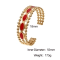 Detailweergave van goudkleurige brede armband met rode emaille golfpatronen en afmetingen - Rood