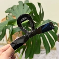 Hand holding a large black butterfly bow hair claw clip with a glossy hollowed design - XL Straight Bow (13.5cm) / Glossy Black