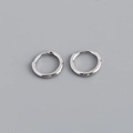 Detailed close-up of polished S925 sterling silver huggie earrings with a mirror finish - 8mm Inner Diameter (Platinum Color)