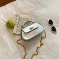 Silver metallic PU crossbody bag with golden turn-lock and chain strap on white fabric - Silver