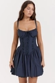 Detail of navy blue corset mini dress showing lace trim and pleated skirt on a model - S / Navy Blue