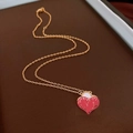 Golden necklace with melting heart pendant on a textured dark background for women - Gold Enamel Red Heart / Gold