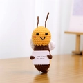 Handmade crochet bee plush with I bee-lieve in you sign on a wooden surface - Bee