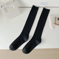 Classic black knee-high socks featuring vertical rib knit pattern and sleek design - One Size / Black