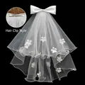 Luminous white bridal veil with satin bow, floral 3D decor, and hair clip attachment - Large Bow Floral Applique Veil