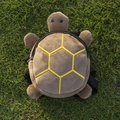 Cute brown plush turtle-shaped backpack for dogs with yellow shell embroidery on green grass - Turtle / Brown