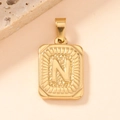 Detailed close-up of a gold-plated square pendant featuring an embossed letter N design - Letter N