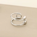 Macro shot of silver-colored double-layer spiral open ring with polished metal finish - US 6