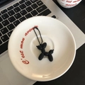Matte black balloon dog keychain with matching bead chain on white ceramic plate - Matte Black