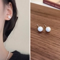 Classic freshwater pearl studs on a model and a wooden background close-up - Silver Pin Imitation Pearl Iridescent Small