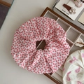 Detail of red bow print cotton scrunchie on a wooden display for a sweet aesthetic style - Rose Pink Fine Bow