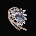 Elegant gold alloy brooch with a large oval crystal and sparkling marquise accents - MM-BR-0039 / Gold